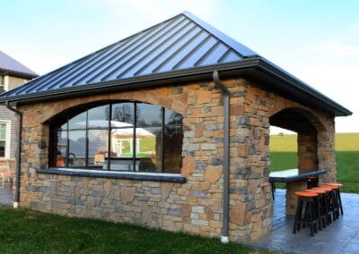 A beautiful covered patio made from warm colored stones.