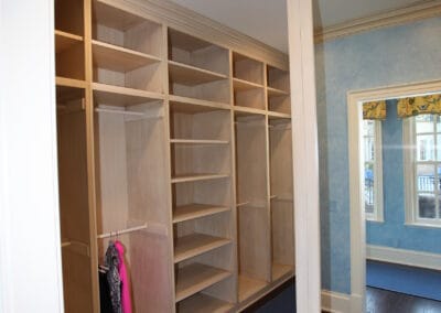 A walk-in closet featuring ample space for storage on shelves and racks.