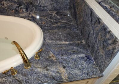 Gorgeous cool toned counters around a bathtub