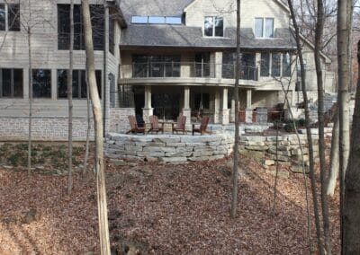 A custom-built two story deck and patio with natural stones.