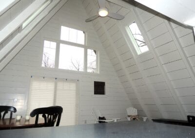 A custom renovated ski cabin featuring white log walls and ceilings