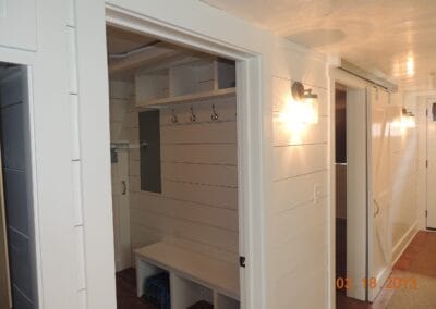 A custom built ski cabin featuring white walls and a mudroom.