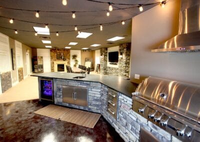 A rustic style showroom featuring stone accent walls and a natural wood dining table.