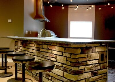 A rustic style showroom featuring a stone bar.