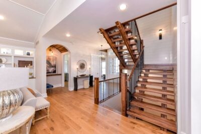 Open concept foyer to living room. Floating stairs between floors.