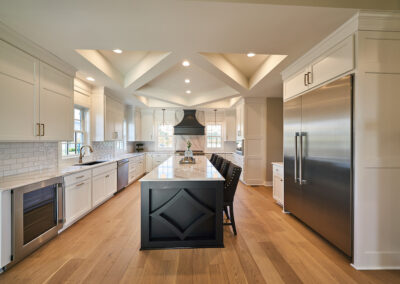 A kitchen featuring a white coffered ceiling with recessed lights. white and grey marble counter top.
