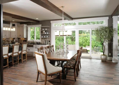 This timeliness kitchen features ceilings with open wooden beams, floating shelves, and wood floors.