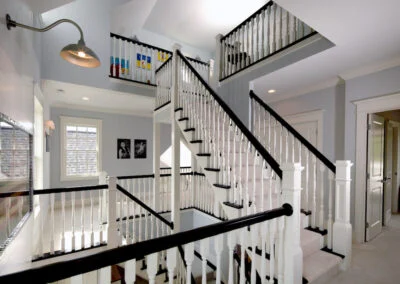 A custom built staircase with white and black banisters.