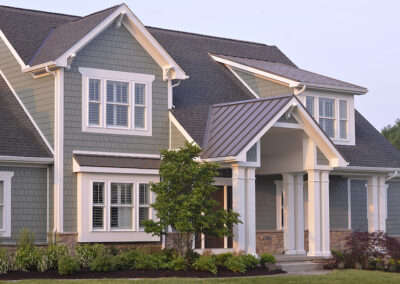 An exterior of a home with grey green siding.